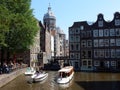 Amsterdam center - canal houses with tower basilica H. Nicolaas Royalty Free Stock Photo